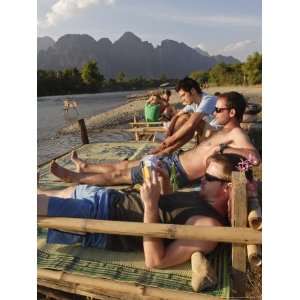 Backpackers Relax by the Nam Song River in Vang Vieng, Laos, Indochina 