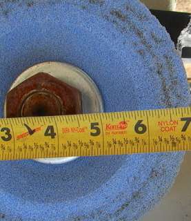 The conical cupped grinding wheel is about 7 inches diameter.