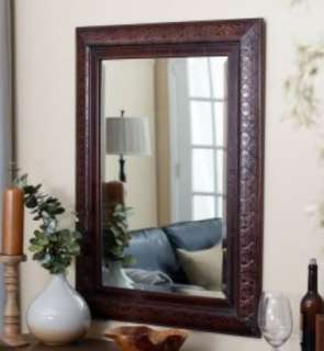   mirror features an embossed design on a copper over wood the copper