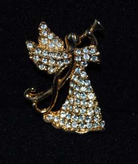 lovely white rhinestone angel pin signed monet that is set in a gold 