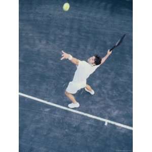  High Angle View of Man Serving a Tennis Ball Premium 